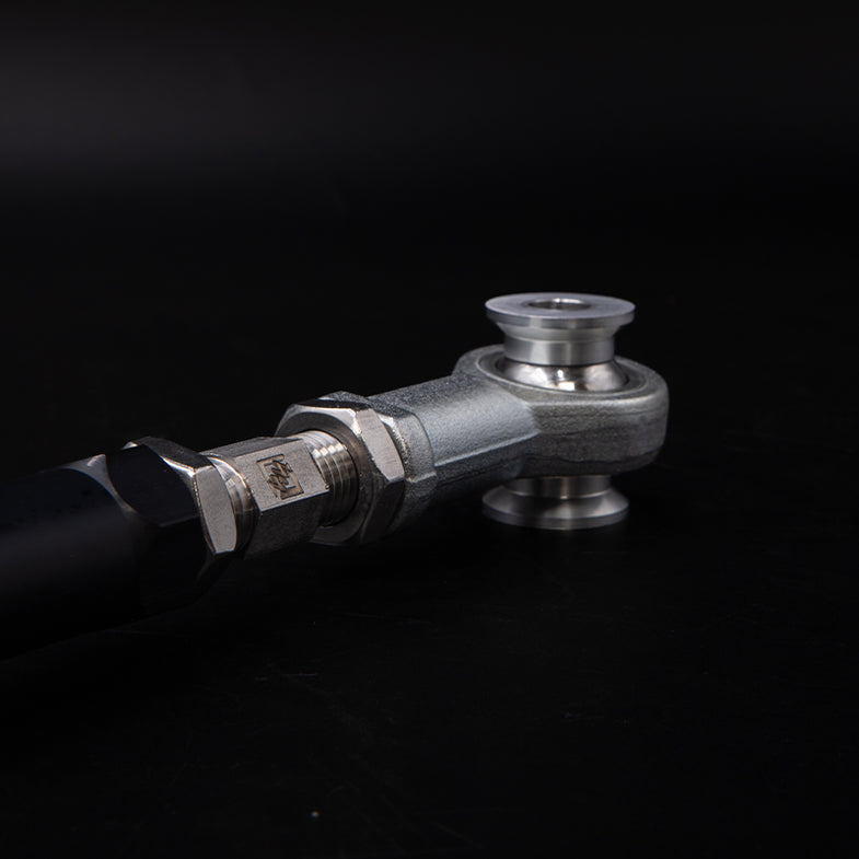 Suspension Secrets adjustable rear traction arms for BMW G87 M2, close-up of suspension linkage components.