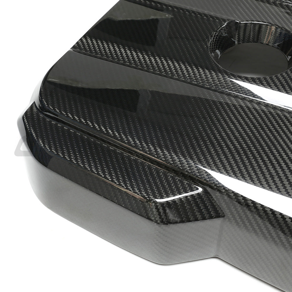 Toyota Supra A90 3.0T B58 carbon fibre engine cover accessory by CT Carbon, featuring a sleek black finish on the engine bay.