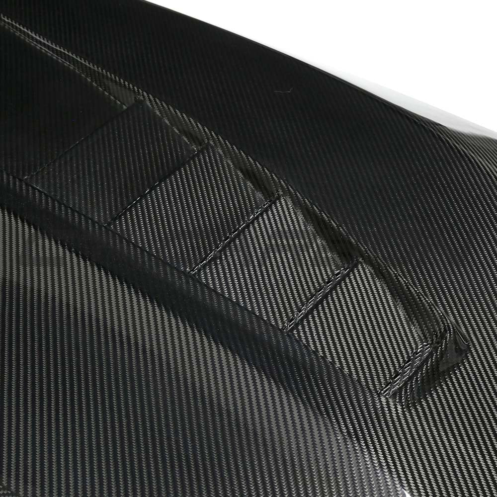BMW F90 M5 and G30 5 Series dry carbon fibre bonnet by CT Carbon, showing sleek lightweight car hood with textured carbon finish.