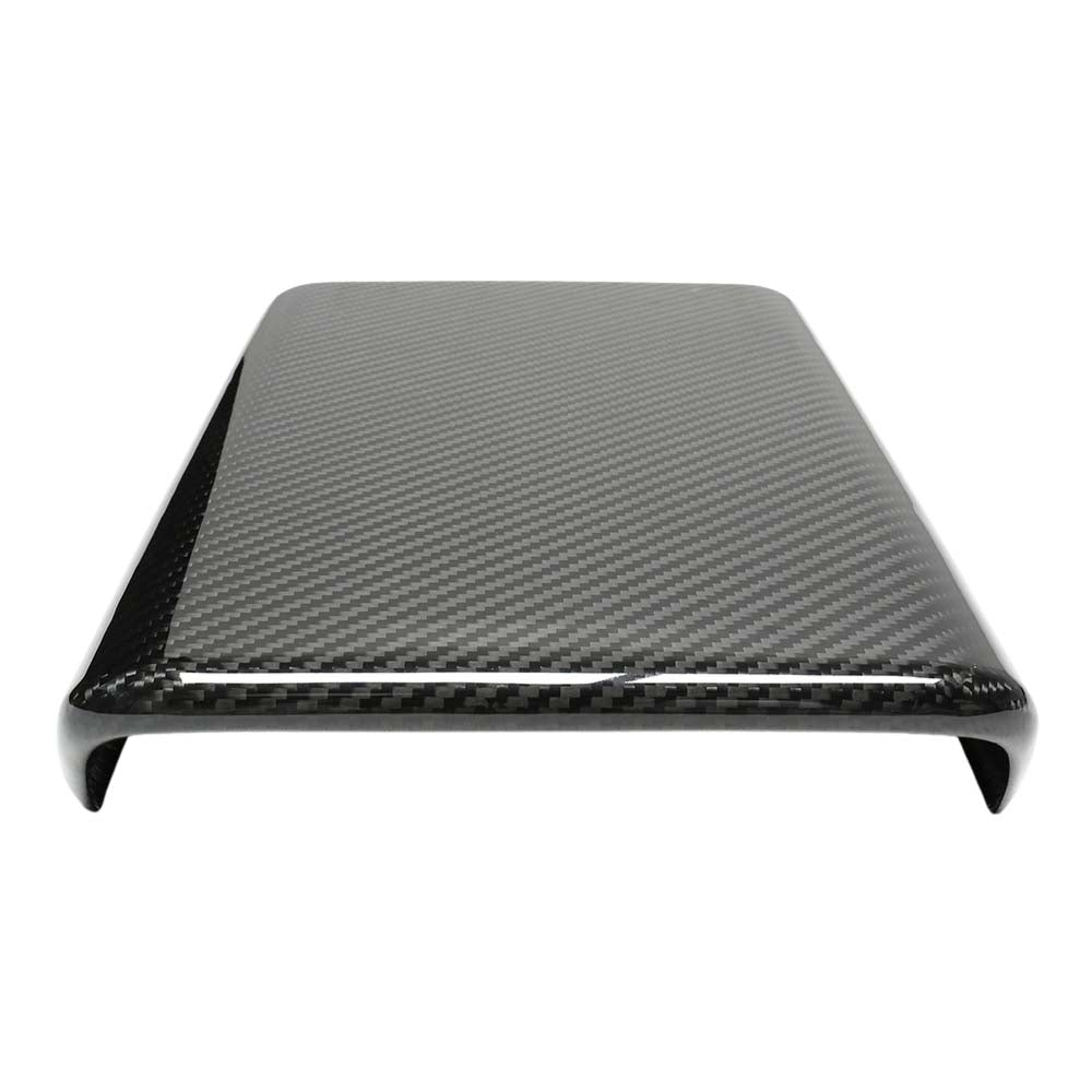 Tesla Model Y 2025+ facelift dry carbon armrest cover by CT Carbon, showing sleek textured carbon fiber surface inside the vehicle.