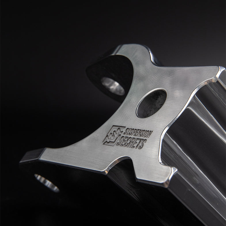 Suspension Secrets camber kit for Porsche 911 GT3 (992) showing adjustable suspension linkages with metal components and mounting points.