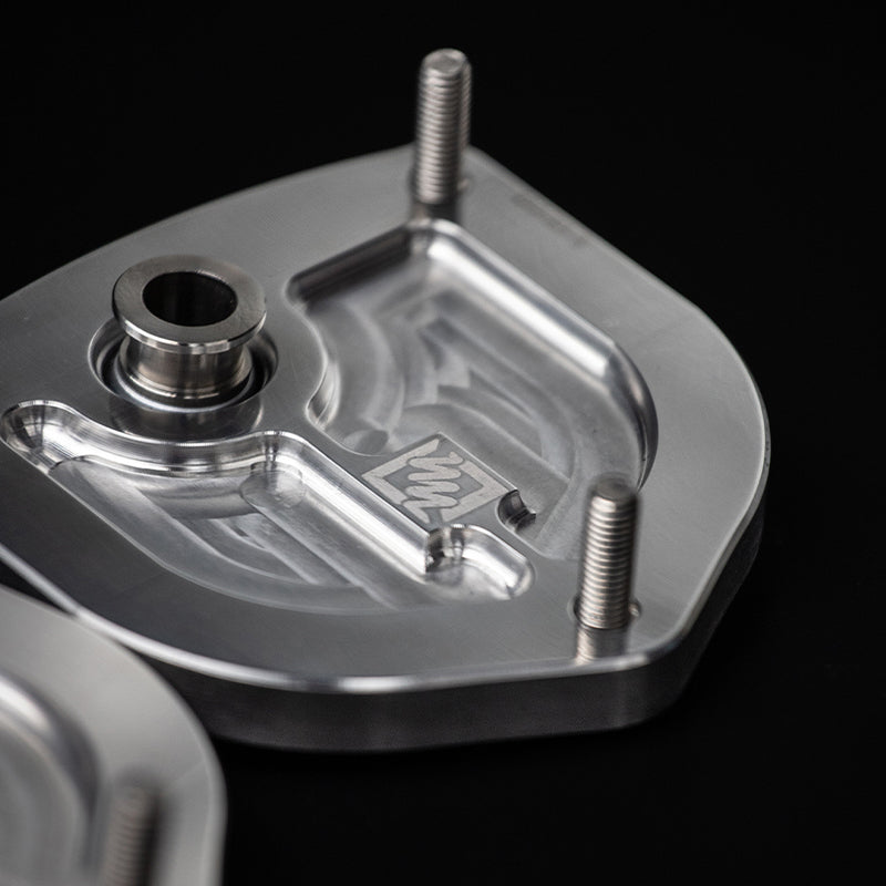 Suspension Secrets camber caster plate top mounts for Porsche 981 and 718 Cayman GT4, showing the suspension linkage components.