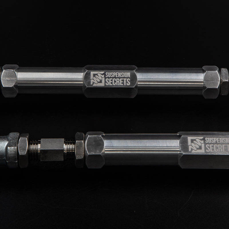 Suspension Secrets adjustable rear toe arms for Porsche 718 GT4 RS, featuring metal links with mounting points for suspension upgrade.