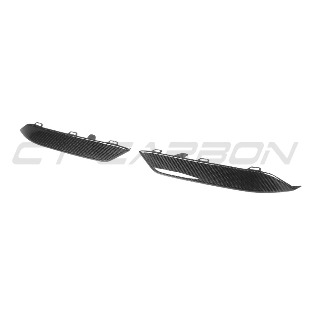 BMW M8 F91/F92/F93 carbon fiber lower front bumper trim by CT Carbon, close-up view of the sleek, textured accessory on the vehicle.