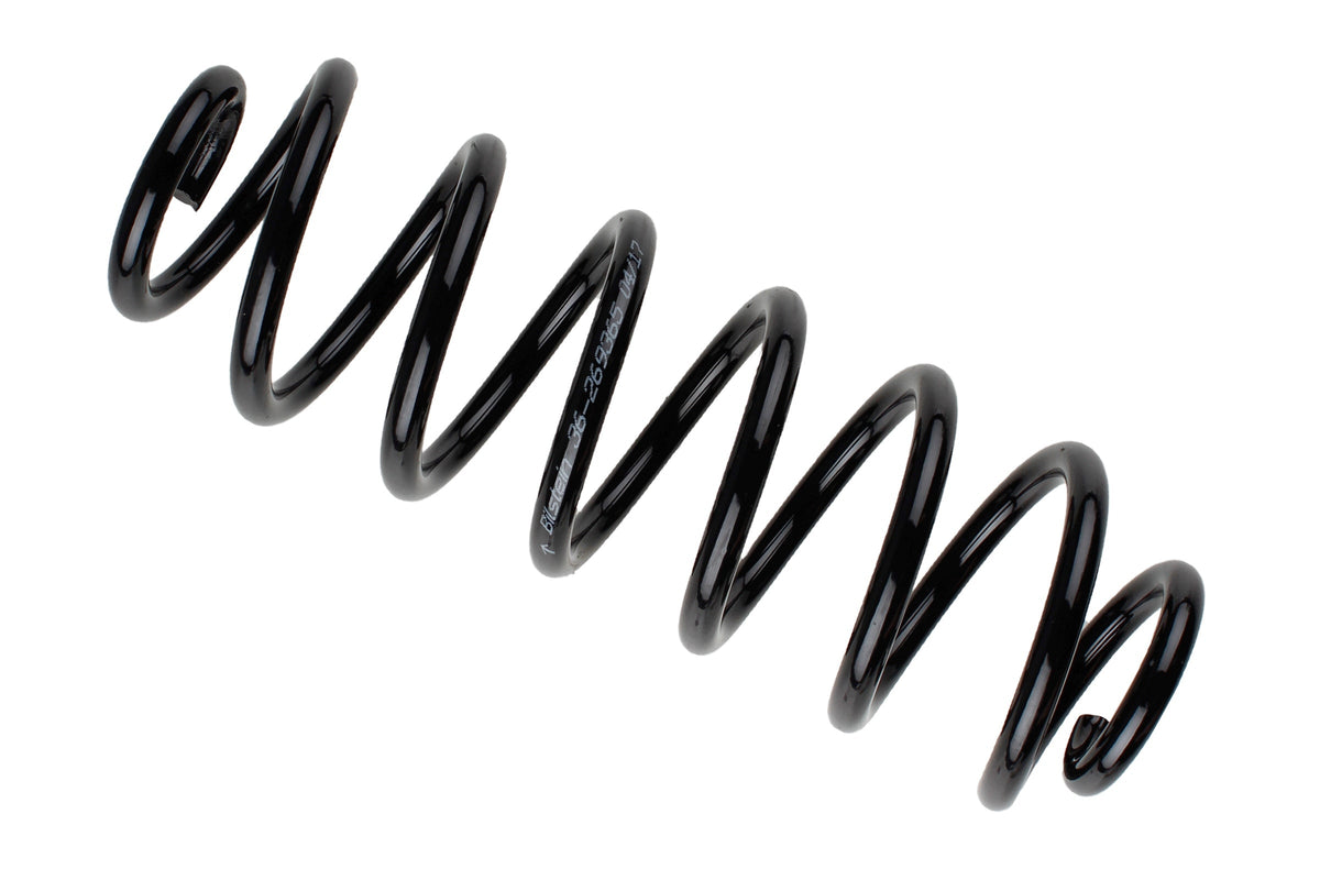 Bilstein B3 OE replacement coil spring for Volkswagen Passat Typ 3C2, part number 36-269365, shows close-up of spring in natural setting.