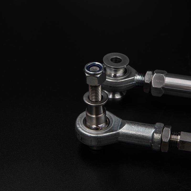 Suspension Secrets adjustable rear toe arms for Porsche 718 GT4 RS, showing the black metal suspension linkage with mounting points.