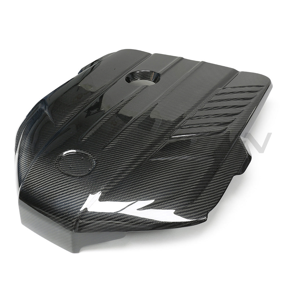 Toyota Supra A90 3.0T B58 carbon fiber engine cover by CT Carbon, showing the sleek, lightweight engine protection accessory.
