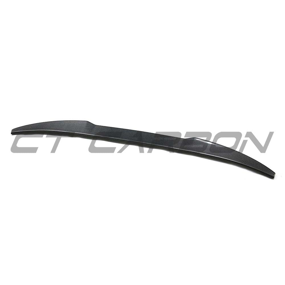 BMW F98 X4M carbon fibre spoiler by CT Carbon, showing the sleek, aerodynamic design mounted on the vehicle's rear edge.