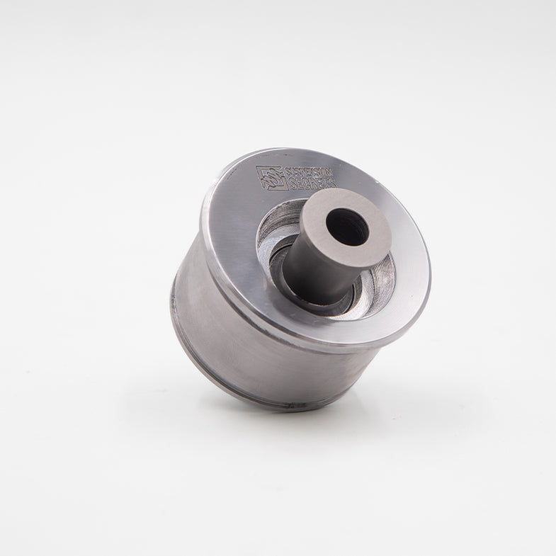 Suspension Secrets front offset caster bushes for BMW G87 M2, automotive suspension linkage component, close-up view.