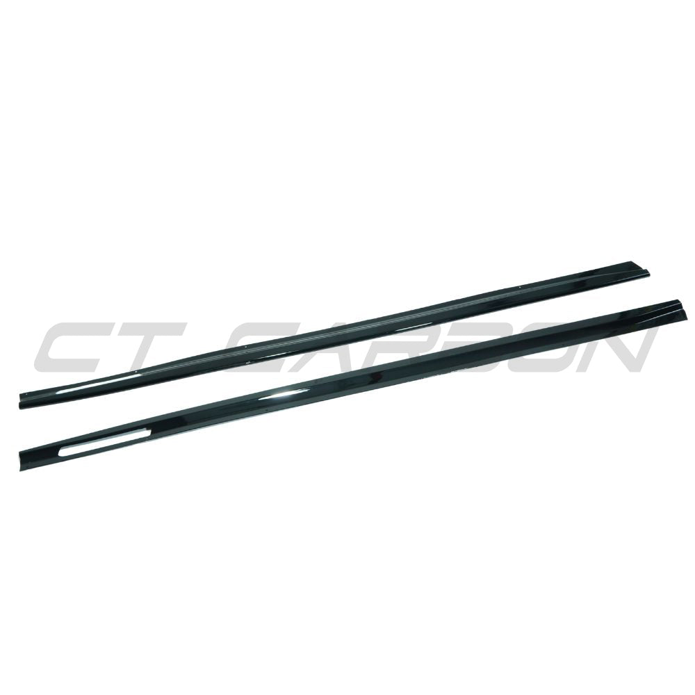 BMW 4 Series G22 G23 CT Carbon gloss black full length side skirts installed on the vehicle, showcasing sleek aerodynamic design.
