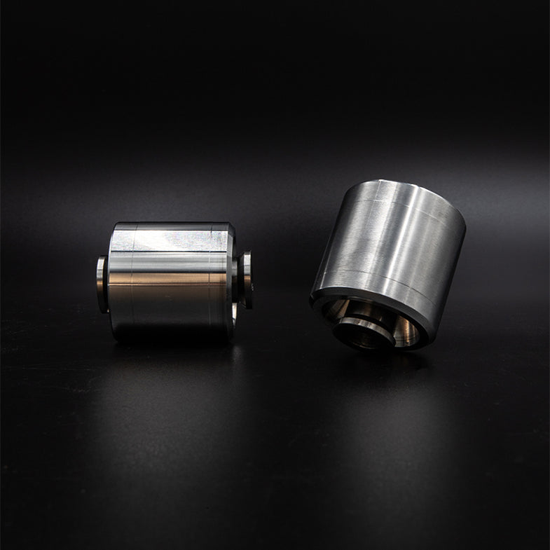 Suspension Secrets solid rear control arm bushes for BMW G87 M2, close-up of black metal suspension linkage components.