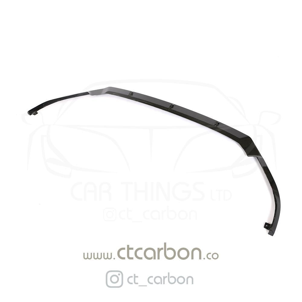 Carbon fiber splitter for VW Golf R MK7.5 by CT Carbon, showcasing sleek, aerodynamic design on a black vehicle front bumper.