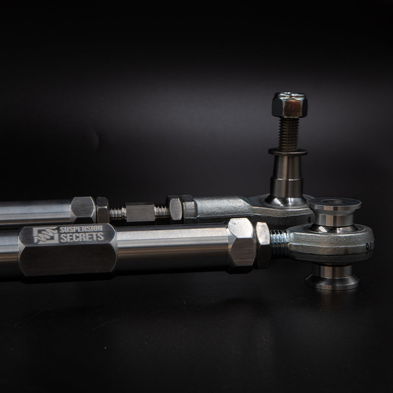 Suspension Secrets adjustable rear toe arms for Porsche 981 and 718 Cayman GT4, showing durable suspension linkage components.