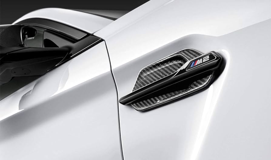 Genuine BMW F87 M2 M Performance carbon side grille air breathers on exterior trim, showcasing sleek black carbon finish.