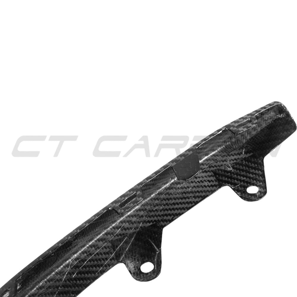 BMW M8 F91/F92/F93 2019+ CT Carbon fiber lower front bumper trim accessory, close-up view showing textured carbon fiber finish.