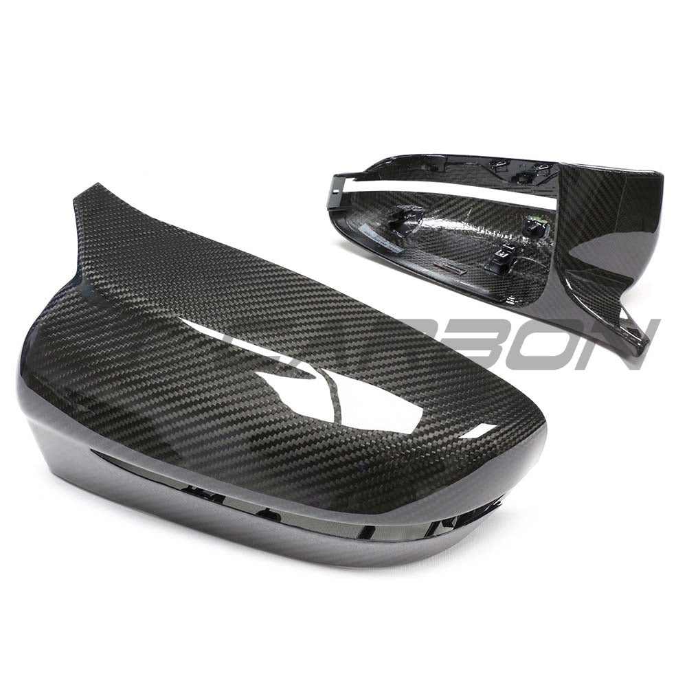 BMW G42 2 Series 2022+ LHD dry carbon mirror cover replacements by CT Carbon, showing sleek, lightweight mirror covers on a car.