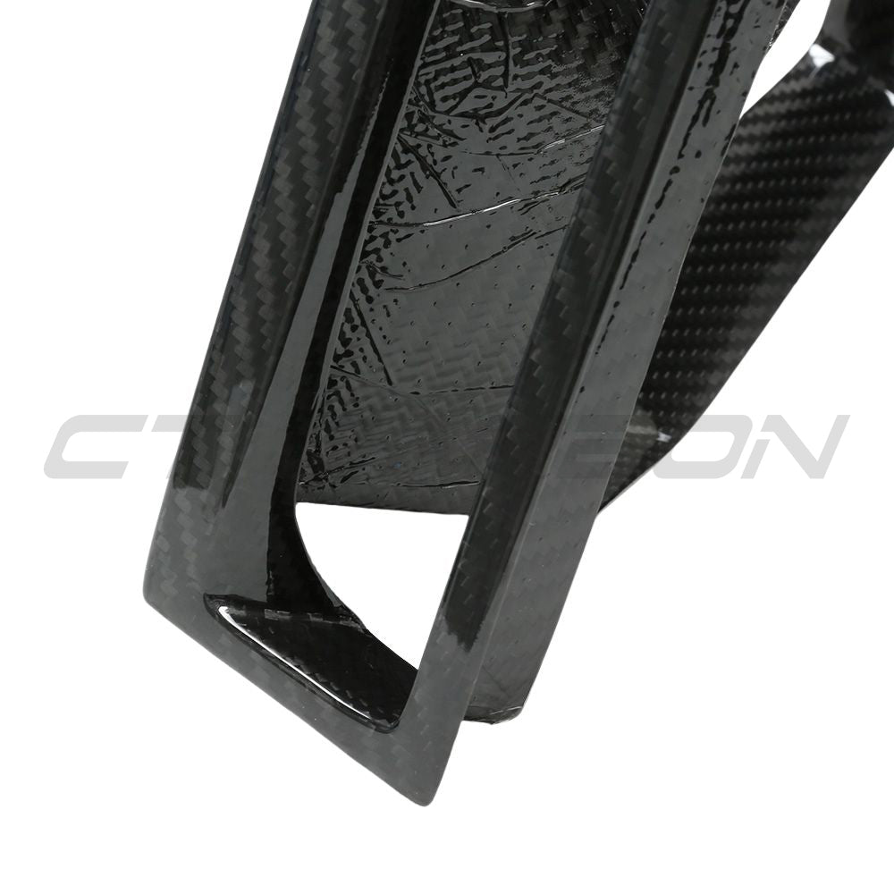 Carbon fibre front bumper middle trim for BMW X3M/X4M F97/F98 LCI 2022+ by CT Carbon, showcasing sleek, textured car accessory.