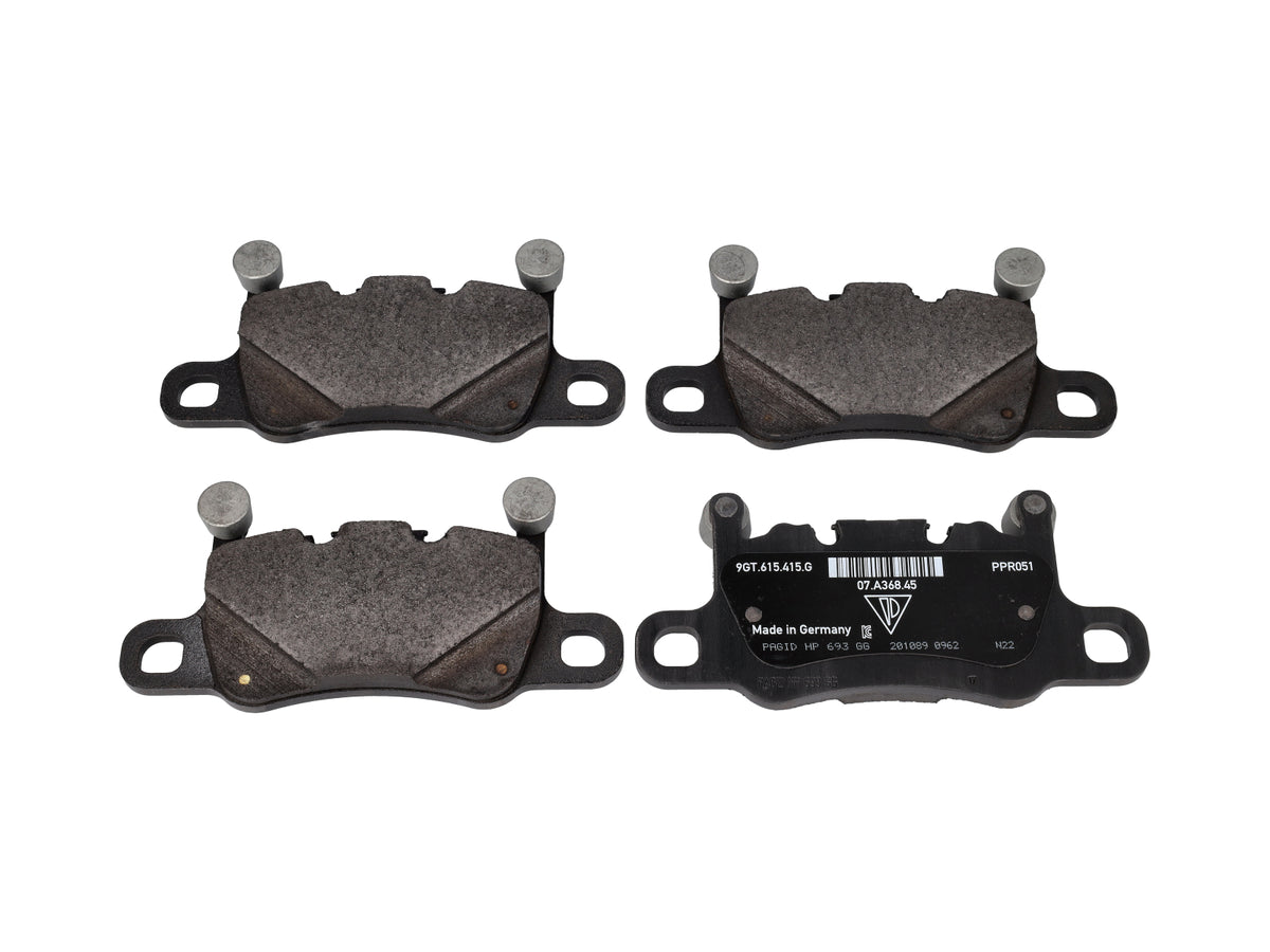 Genuine Porsche rear brake pads for Porsche 718 Cayman GT4 PDK, showing the brake pad set with branding and metallic backing plates.