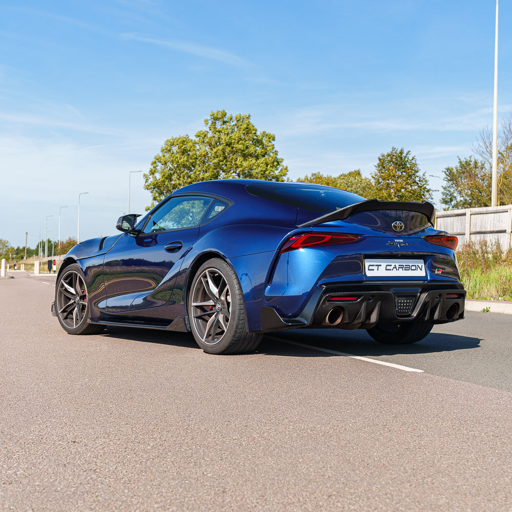 Toyota Supra 2019+ A90 CT Carbon V2 spoiler in black carbon fibre, shown on the car's rear with a sleek, aerodynamic design.