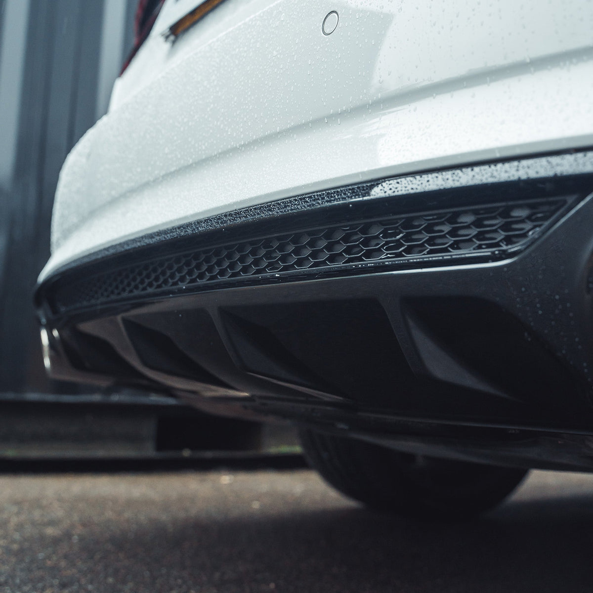 Gloss black diffuser for Audi A5/S5 B9 (2016-2019) by CT Carbon, shown installed on the rear bumper.