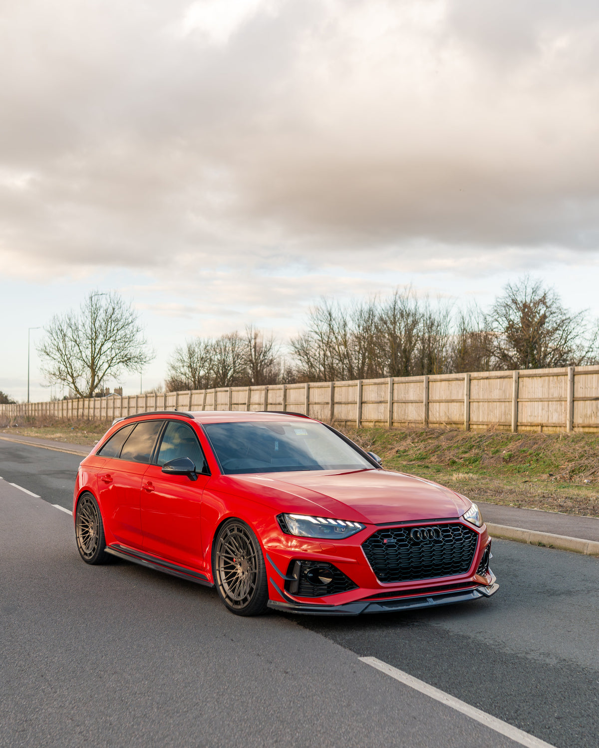 Audi RS4 B9.5 carbon fiber splitter by CT Design, shown on the front of the sporty sedan with sleek carbon fiber finish.