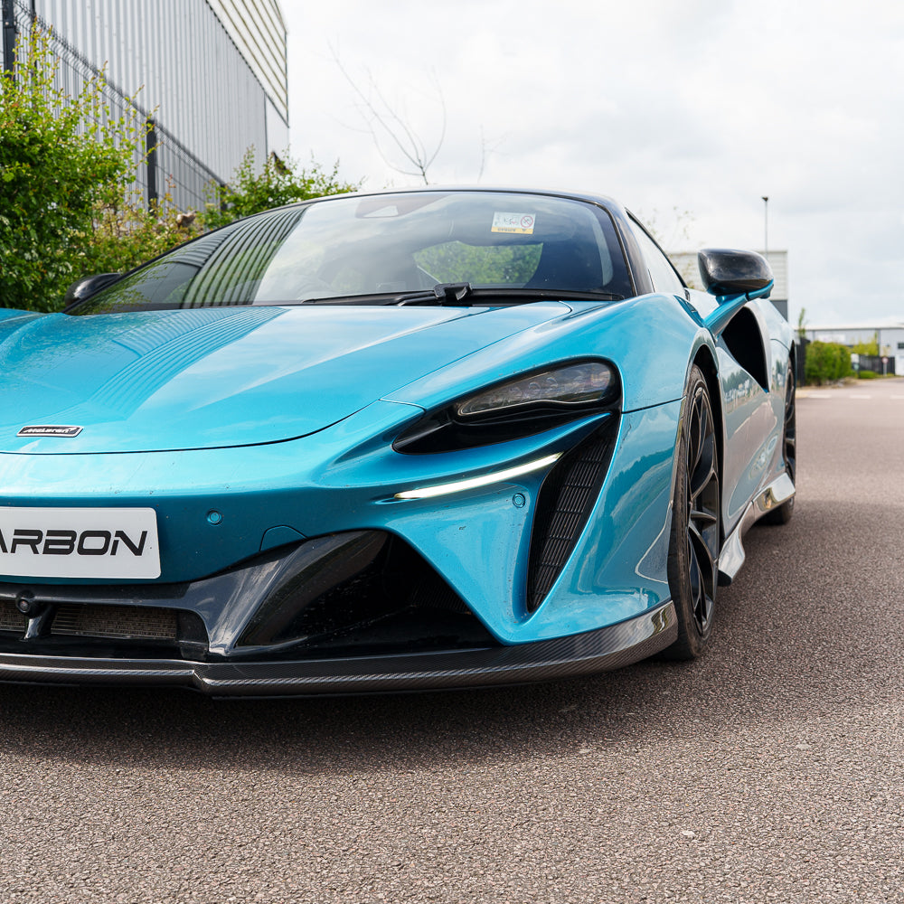 Carbon fiber splitter for McLaren Artura 2023 by CT Carbon, showcasing sleek, aerodynamic design and textured surface.