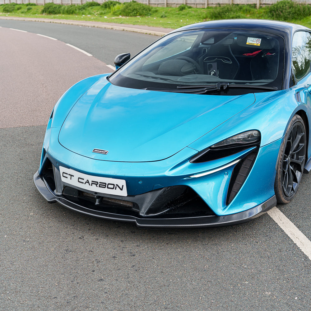 Carbon fiber splitter for the McLaren Artura 2023 by CT Carbon, showing the sleek, aerodynamic design on the front of the car.