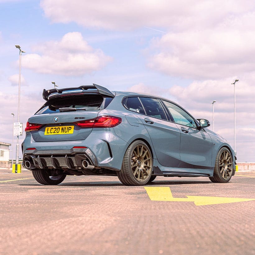 BMW 1 Series F40 carbon fiber side skirts by CT Carbon, sleek and aerodynamic, shown installed on the vehicle.