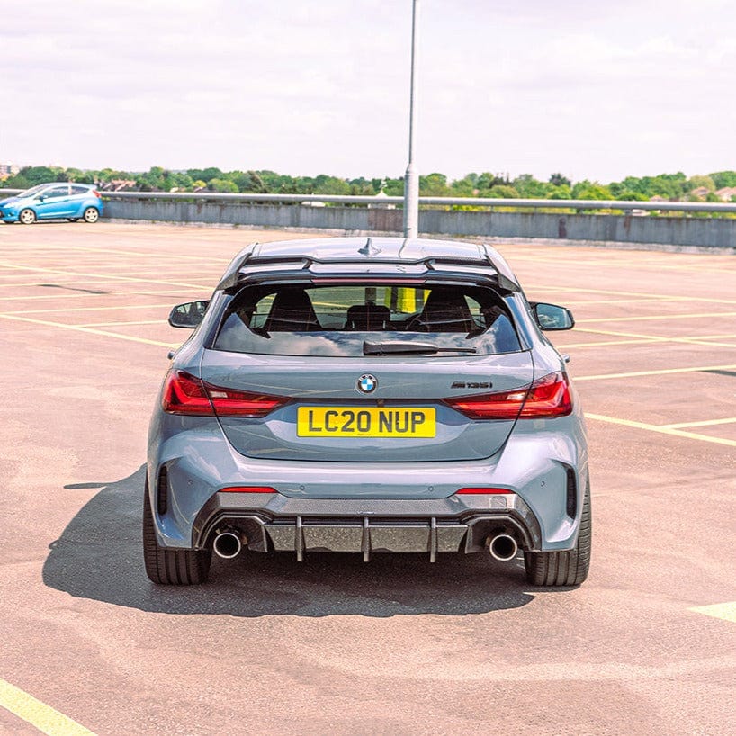 BMW 1 Series F40 F70 carbon fiber spoiler by CT Design, shown on the vehicle with sleek, aerodynamic design and carbon fiber finish.