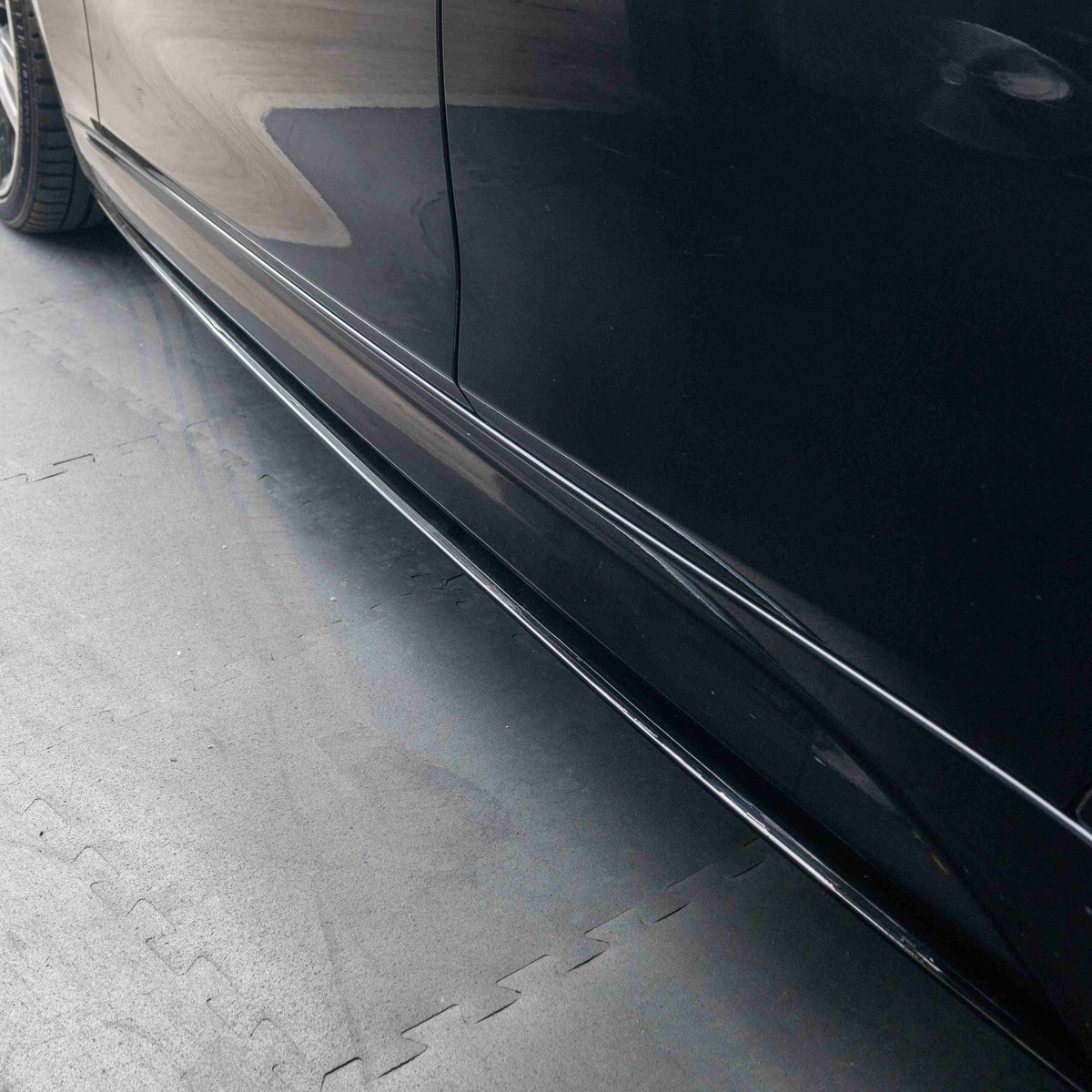 BMW 3 Series F30/F31 GLOSS BLACK side skirts by CT Carbon, MP style, mounted on vehicle, showcasing sleek aerodynamic design.