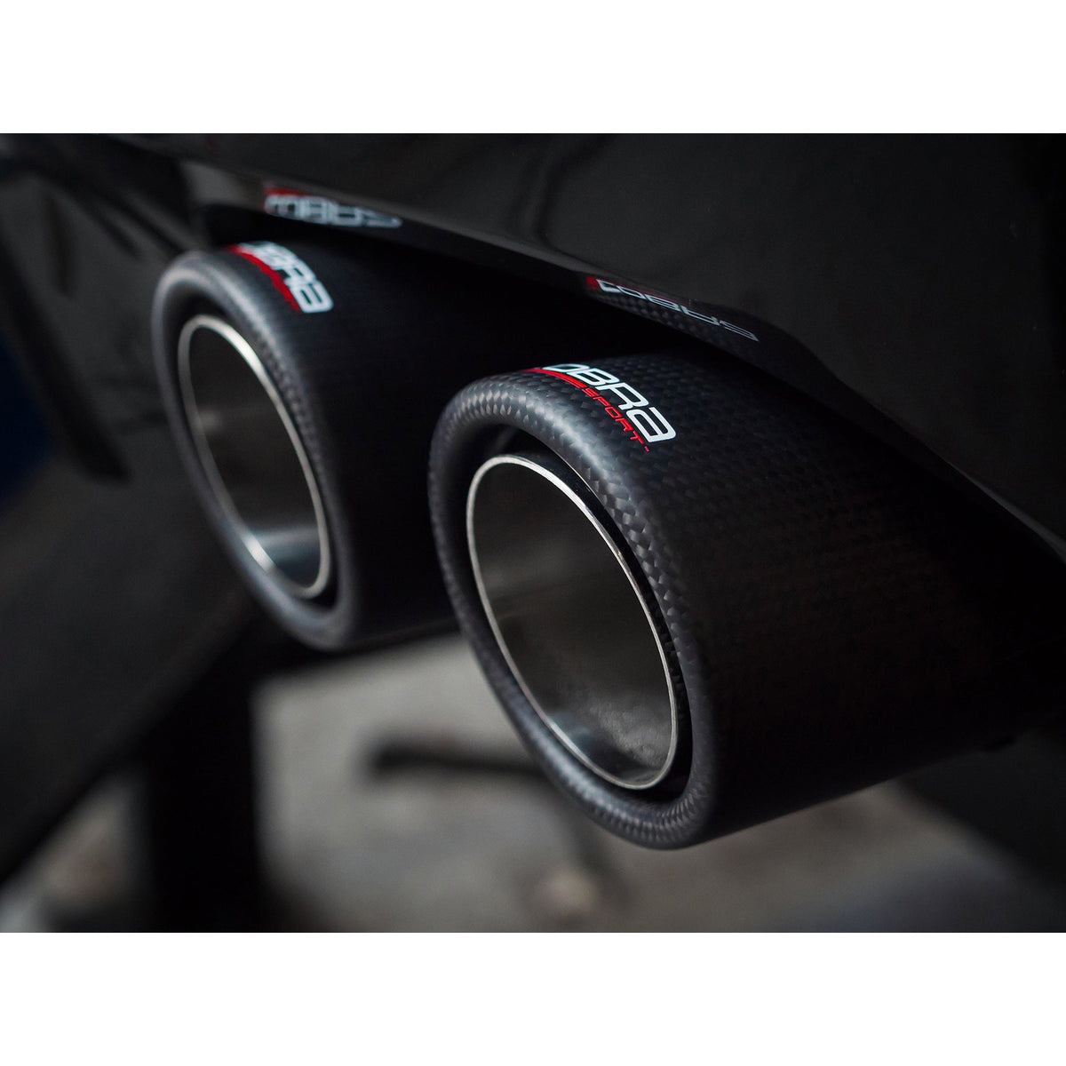 BMW 320i G20 Cobra Sport non-valved quad exit M3 style performance exhaust installed on vehicle.