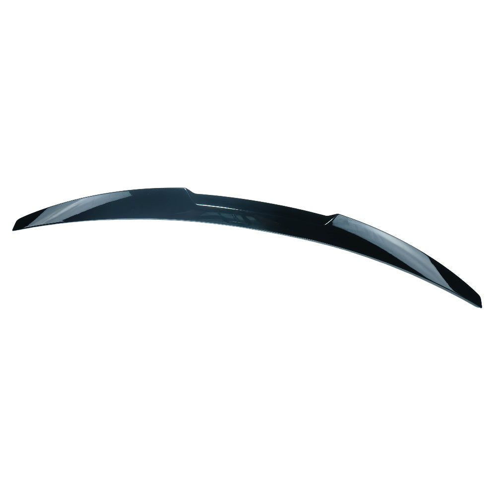 BMW 4 Series G22 2020+ gloss black V3 spoiler by CT Carbon installed on the car's rear, enhancing sporty appearance.