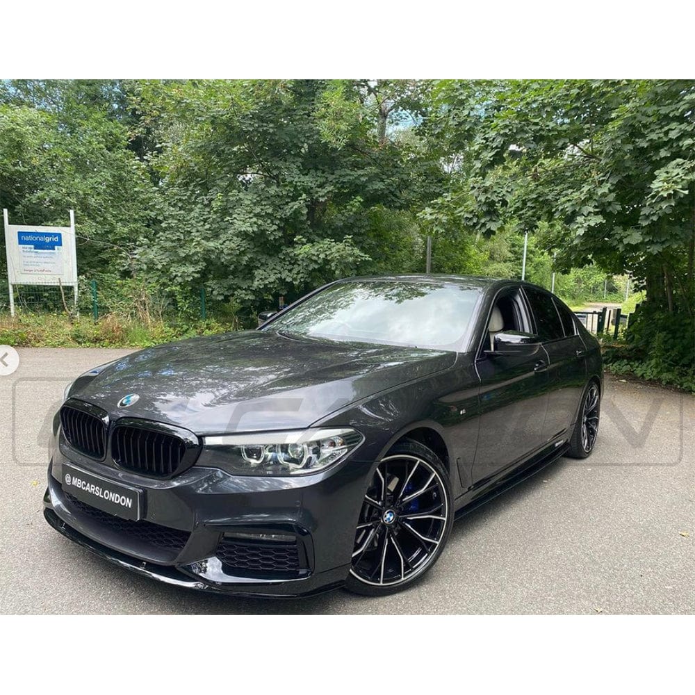 BMW 5 Series G30 gloss black full kit by CT Carbon, featuring MP style components, shown on a sleek vehicle.