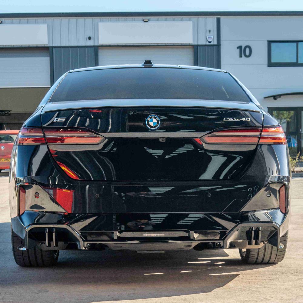 BMW 5 Series G60 and i5 2023 CT Carbon gloss black diffuser installed on the rear bumper.