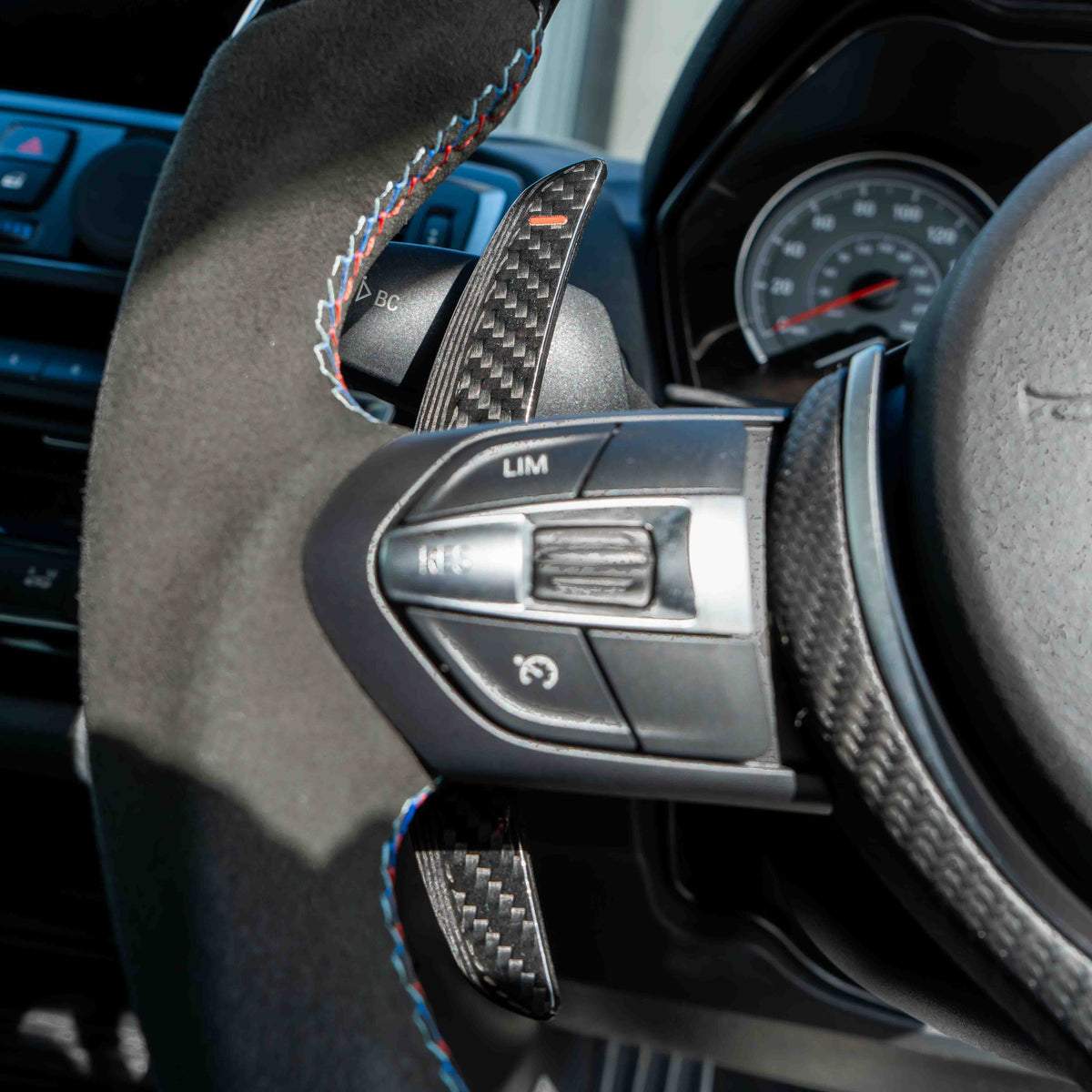 BMW carbon fiber magnetic shifter paddles by CT Carbon, featuring sleek black design and lightweight construction for sporty driving.