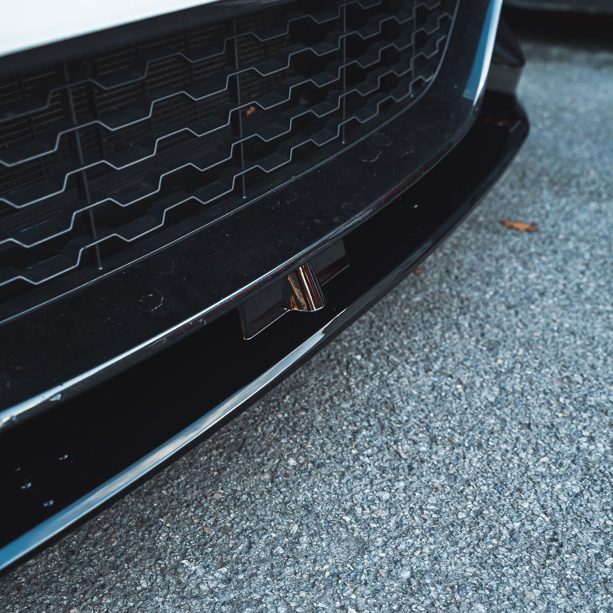 BMW F20 F21 1 Series LCI gloss black splitter by CT Carbon, showing the sleek, aerodynamic front splitter on the car's bumper.