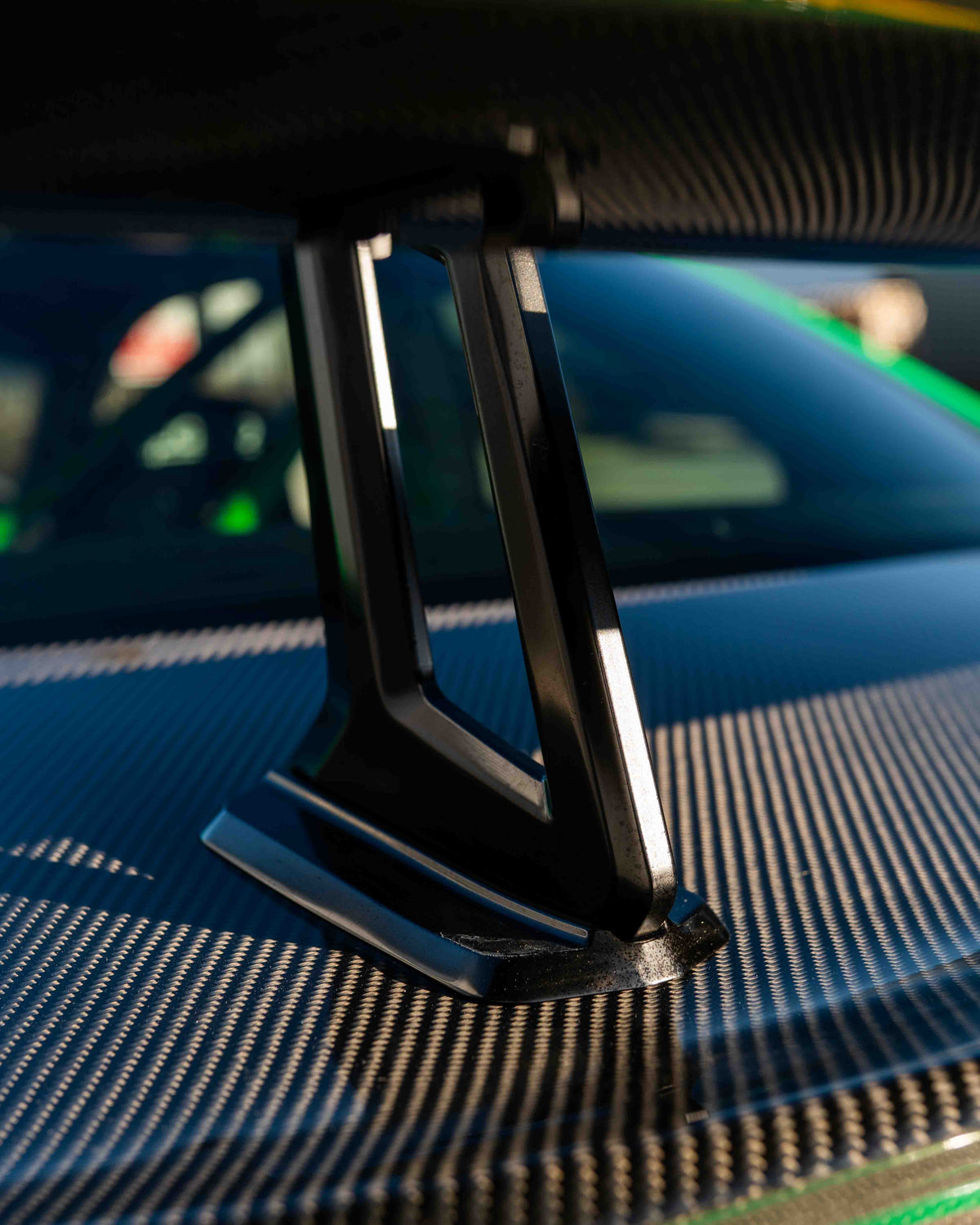 BMW F87 M2 and F22 2 Series carbon fiber swan neck wing spoiler by CT Carbon, showcasing sleek aerodynamic design.