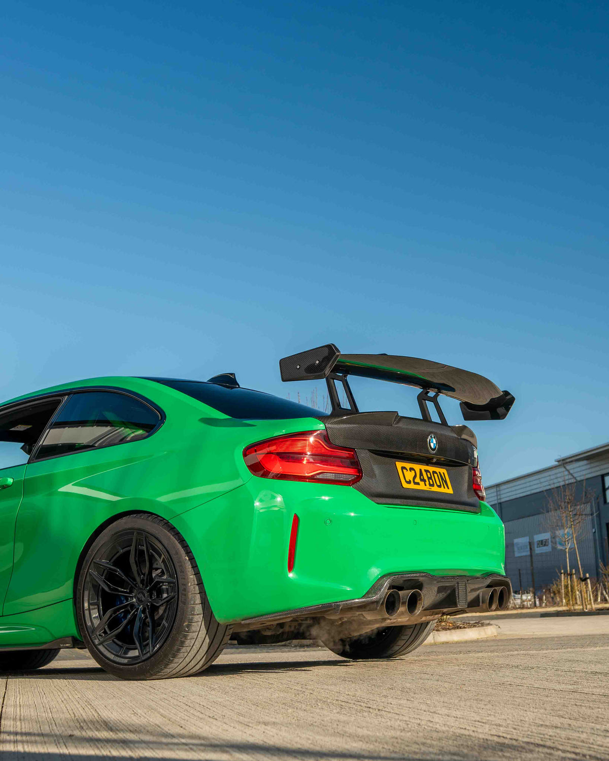 BMW F87 M2 and F22 2 Series carbon fiber swan neck wing spoiler by CT Carbon, showcasing sleek, aerodynamic design.