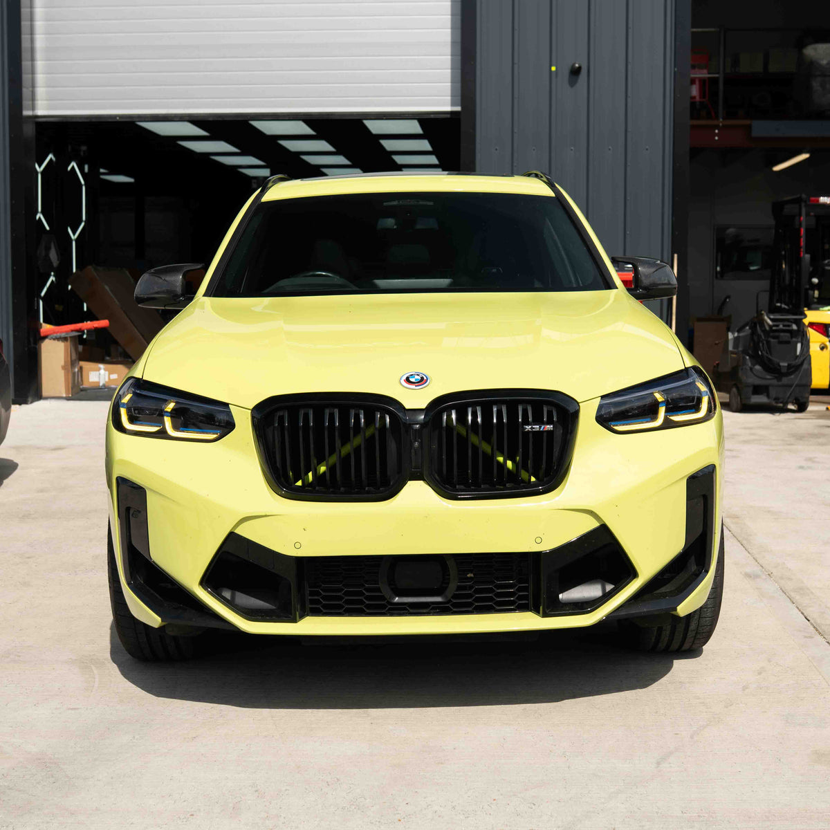 BMW F97 X3M LCI yellow adaptive DRL module set by CT Carbon, showing close-up of the LED daytime running lights.