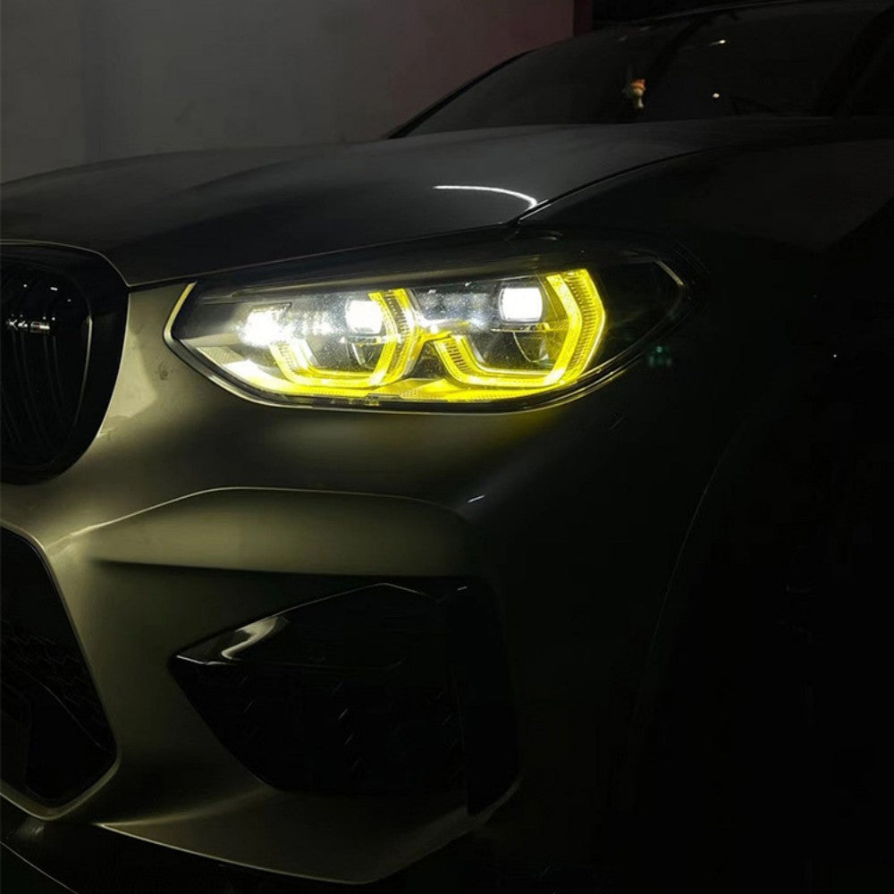 BMW G01 X3 pre-LCI yellow adaptive DRL module set by CT Carbon, showing the car's front daytime running lights in yellow.