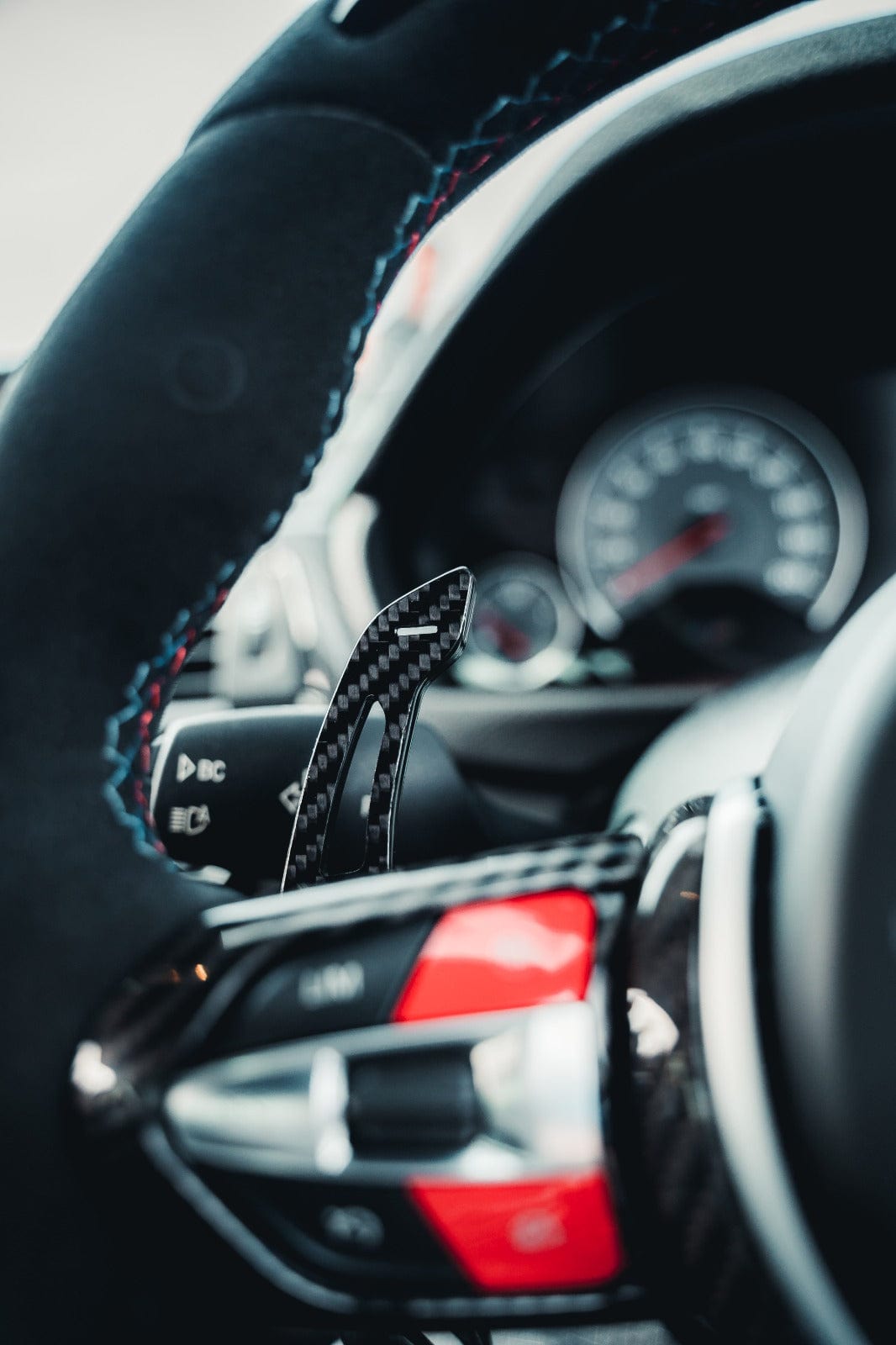 BMW Fxx carbon fiber shifter paddles from CT Carbon, showcasing sleek, lightweight racing-style accessories with textured finish.