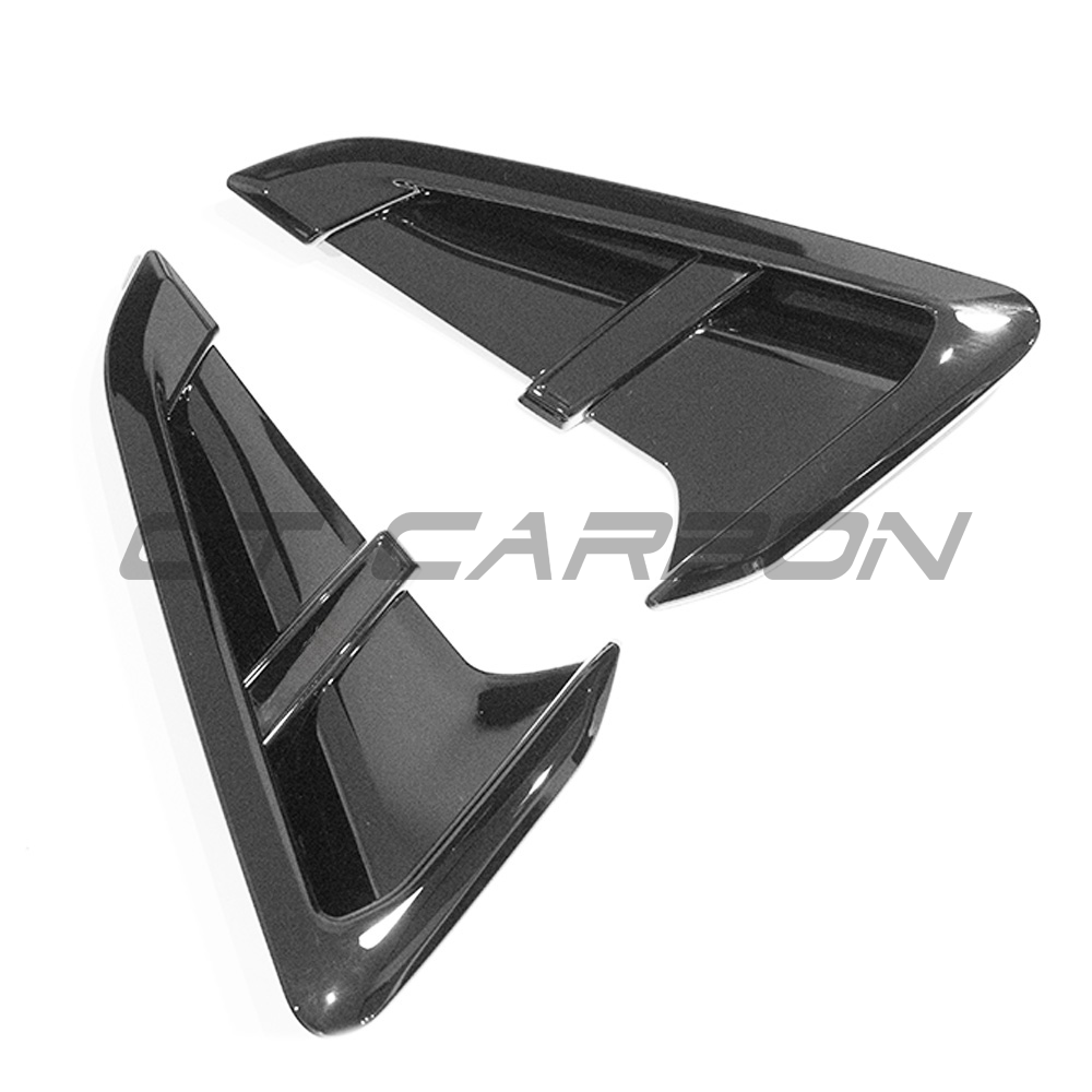 BMW G01 X3 gloss black fender trims by CT Carbon, close-up of sleek, shiny accessory on vehicle's wheel arches.