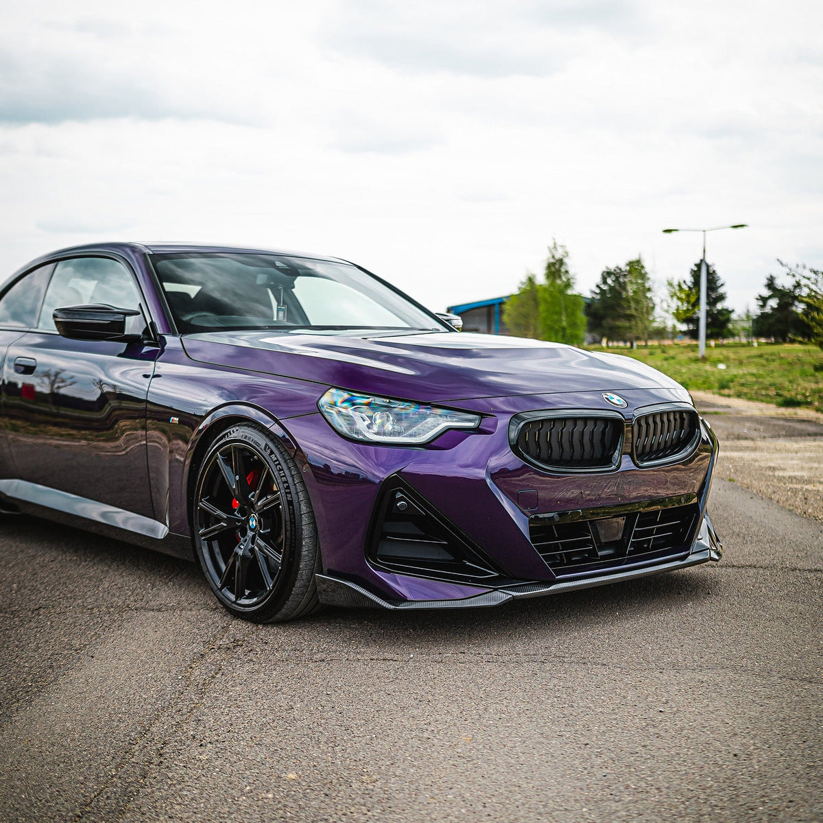 BMW G42 2 Series carbon fiber splitter by CT Carbon, V1, showcasing sleek aerodynamic design and lightweight construction.