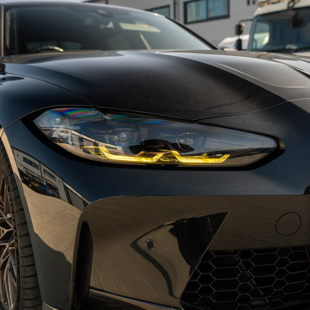 BMW G80 G81 G82 G83 M3 M4 yellow LED DRL module set by CT Carbon, showing the bright yellow daytime running lights.