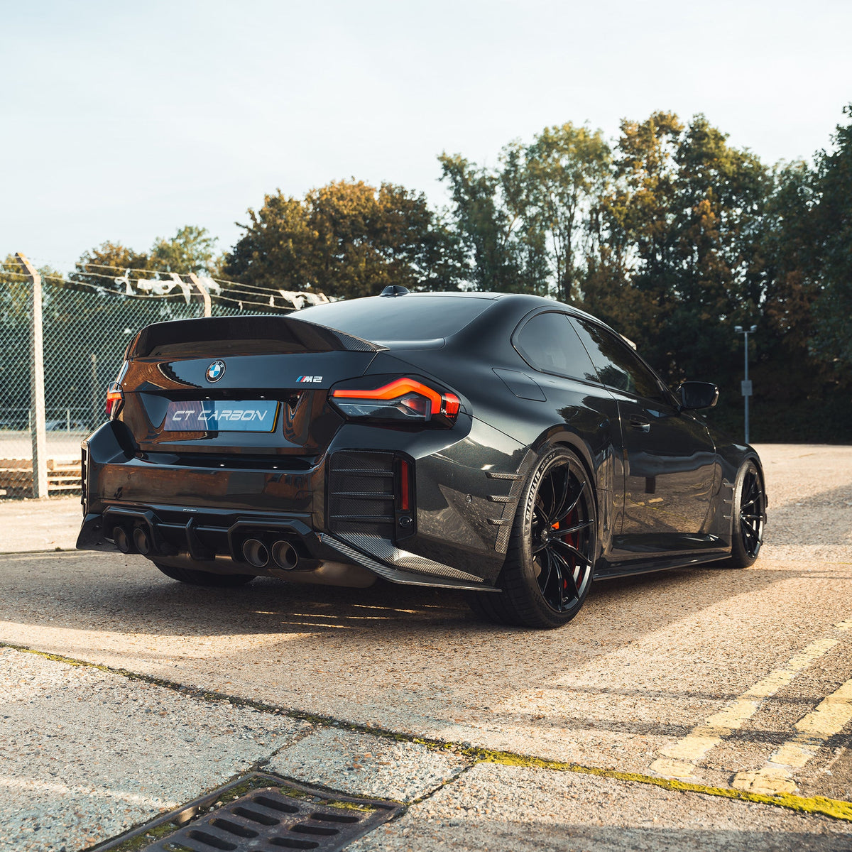 BMW G87 M2 carbon fiber diffuser by CT Design, showcasing a sleek, aerodynamic rear diffuser with carbon fiber finish.