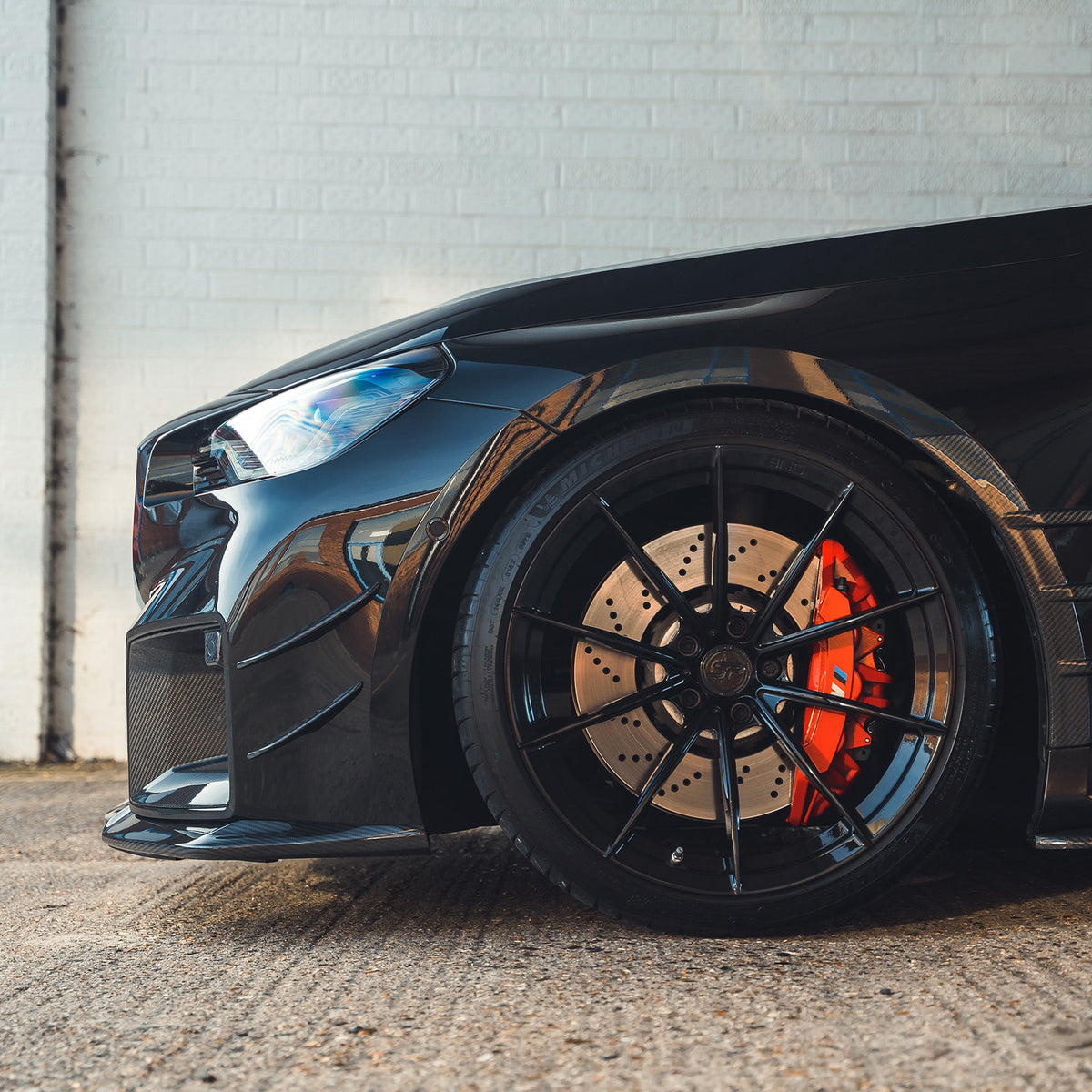 BMW G87 M2 carbon fiber front bumper canards by CT Carbon, showcasing sleek aerodynamic accessories for enhanced performance.