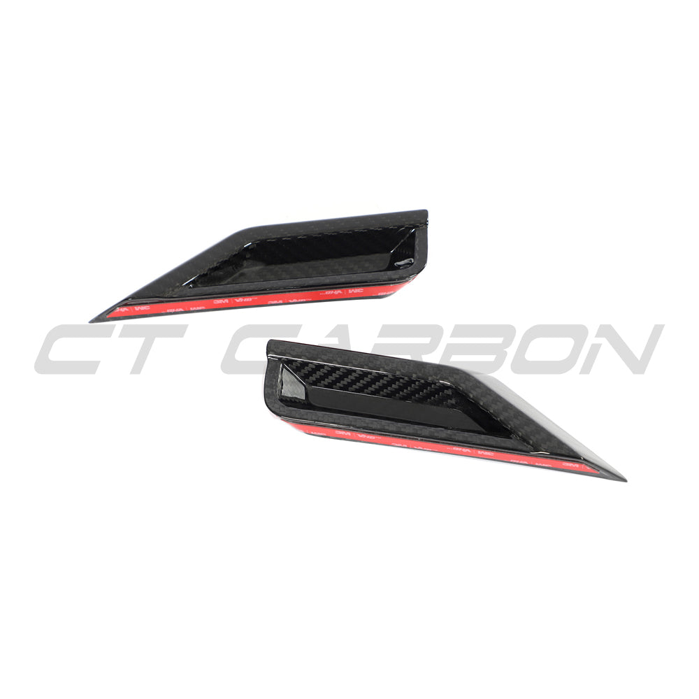 BMW G87 M2 carbon fiber front headlight add-on accessory by CT Design, showcasing sleek carbon fiber detail on the headlights.