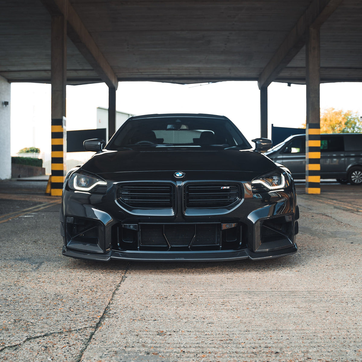 BMW G87 M2 carbon fibre splitter by CT Design, showcasing the lightweight, aerodynamic front splitter with detailed carbon fibre weave.