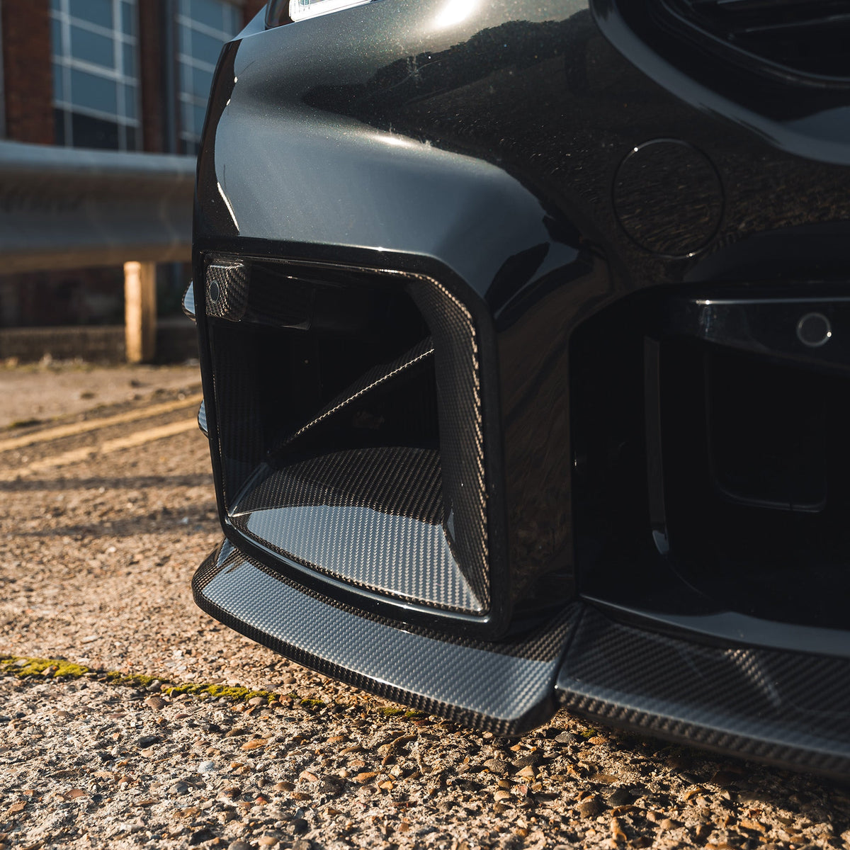 BMW G87 M2 carbon fibre splitter by CT Design, showcasing the sleek, lightweight aerodynamic splitter with detailed carbon fibre texture.
