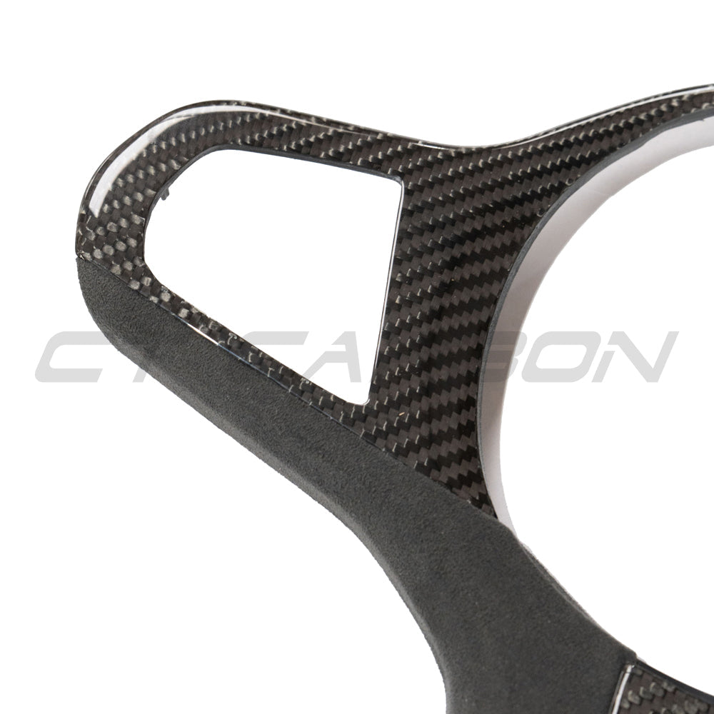 BMW Gxx M series carbon fiber steering wheel trim accessory by CT Carbon, showcasing sleek, textured carbon fiber finish.